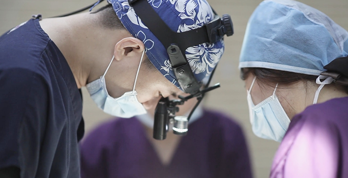 Wearing a high-magnification loupe